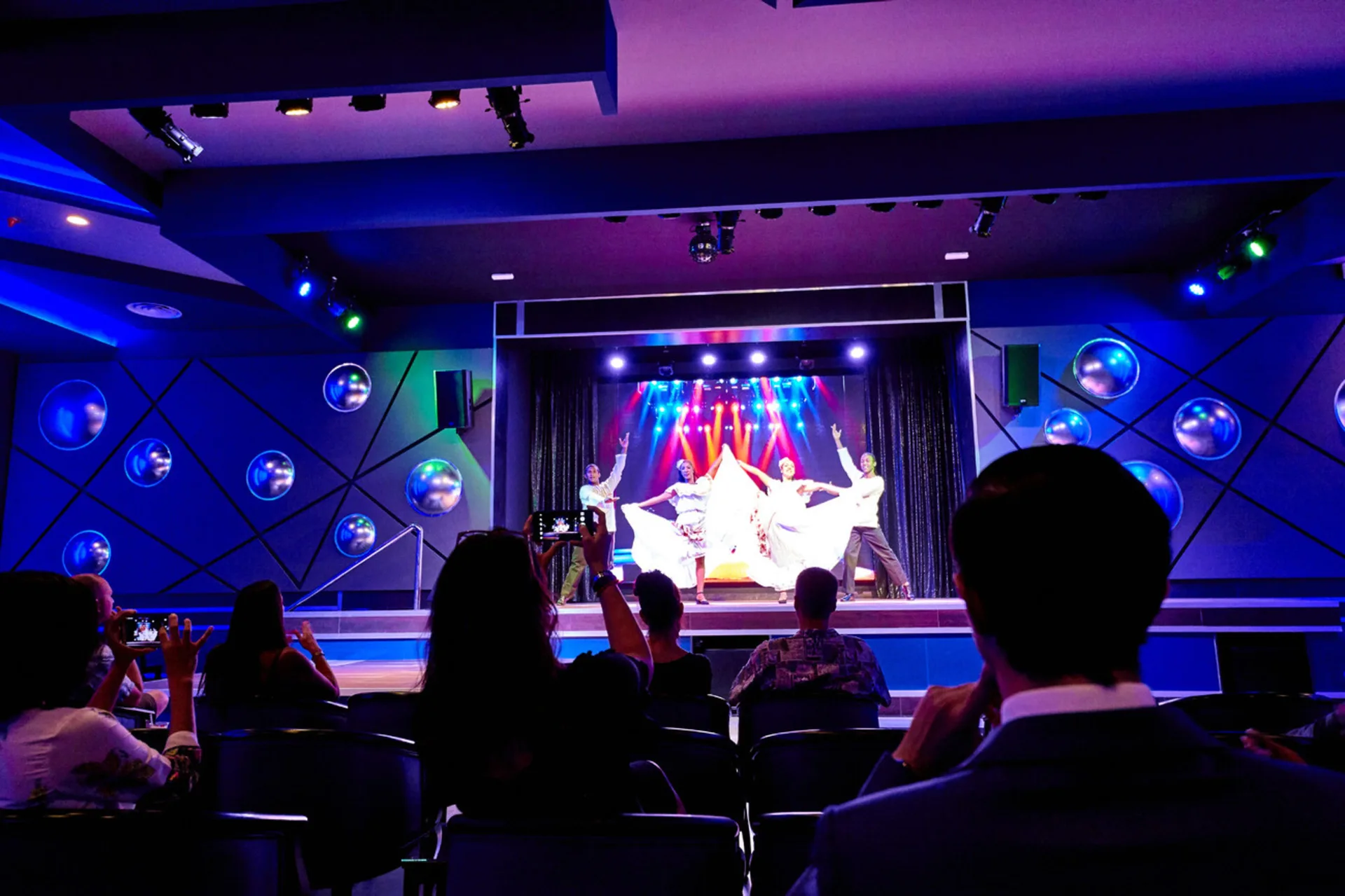 Live stage performance with audience seating at Hotel Riu Palace Paradise Island.