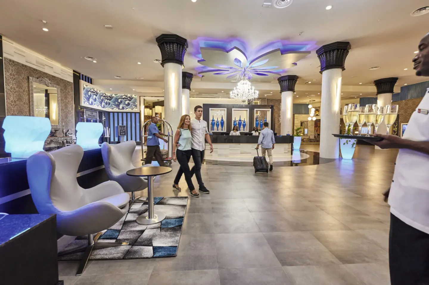 Lobby welcome scene with drinks and reception desk at Hotel Riu Palace Paradise Island.