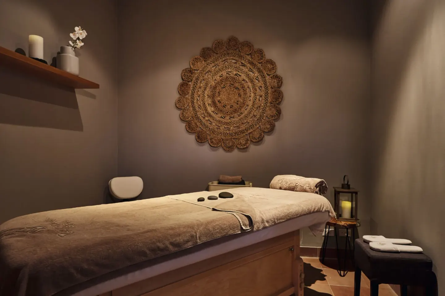 Massage treatment room with a table and warm lighting at Hotel Riu Palace Paradise Island.