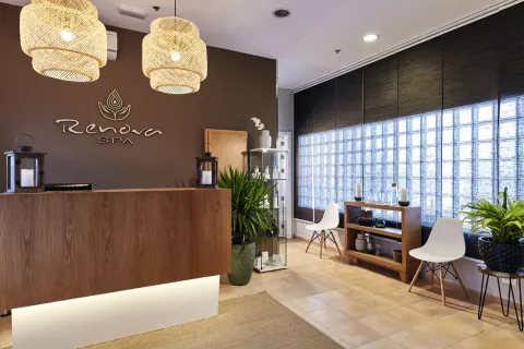 Spa reception with wood desk and seating at Hotel Riu Palace Paradise Island.