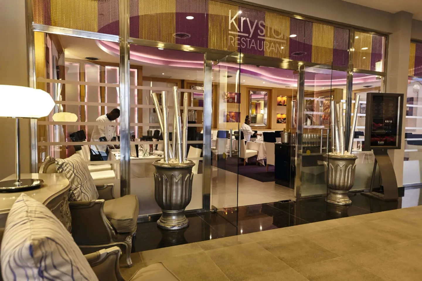 Krystal restaurant entrance with glass doors at Hotel Riu Palace Paradise Island.