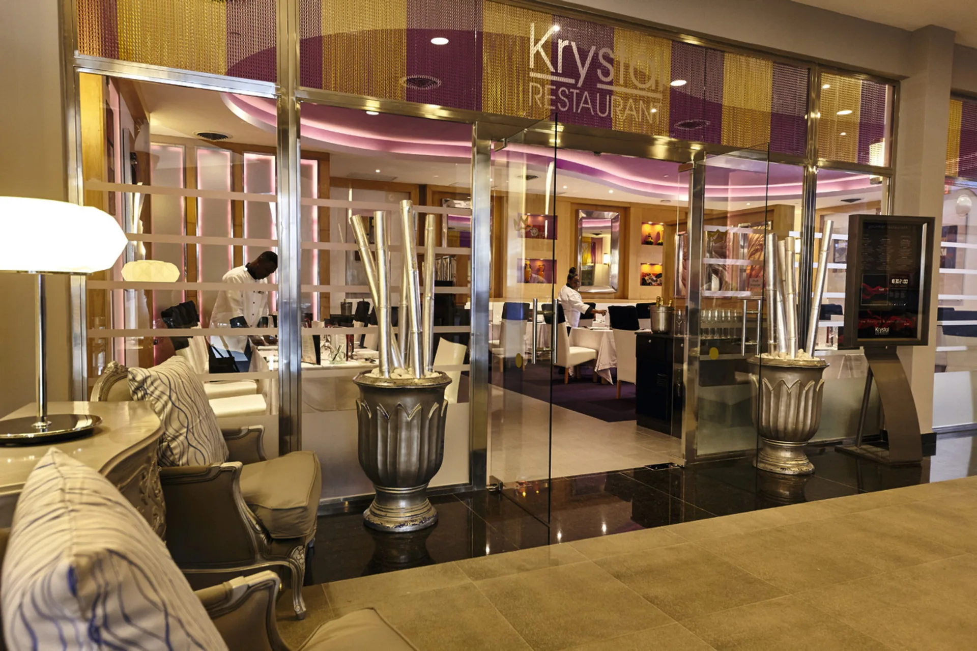 Krystal restaurant entrance with glass doors at Hotel Riu Palace Paradise Island.