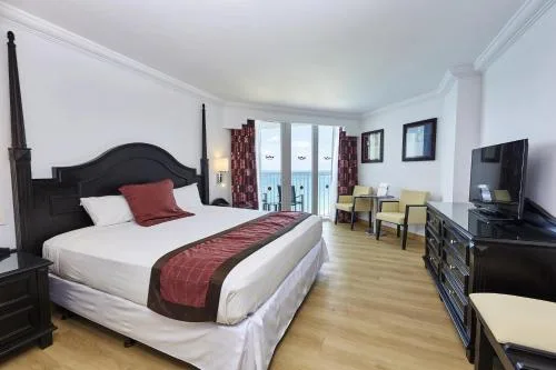 2 Bedroom Junior Suite Ocean View bedroom with king bed at Hotel Riu Palace Paradise Island.
