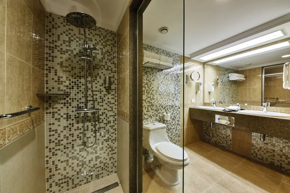Junior Suite Ocean View bathroom with glass shower at Hotel Riu Palace Paradise Island.