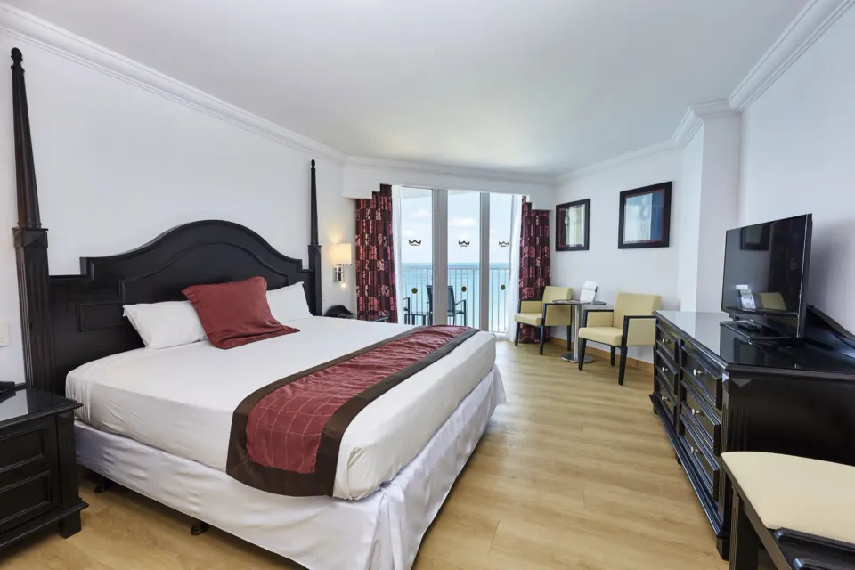 Junior Suite Ocean View king bed and balcony at Hotel Riu Palace Paradise Island.