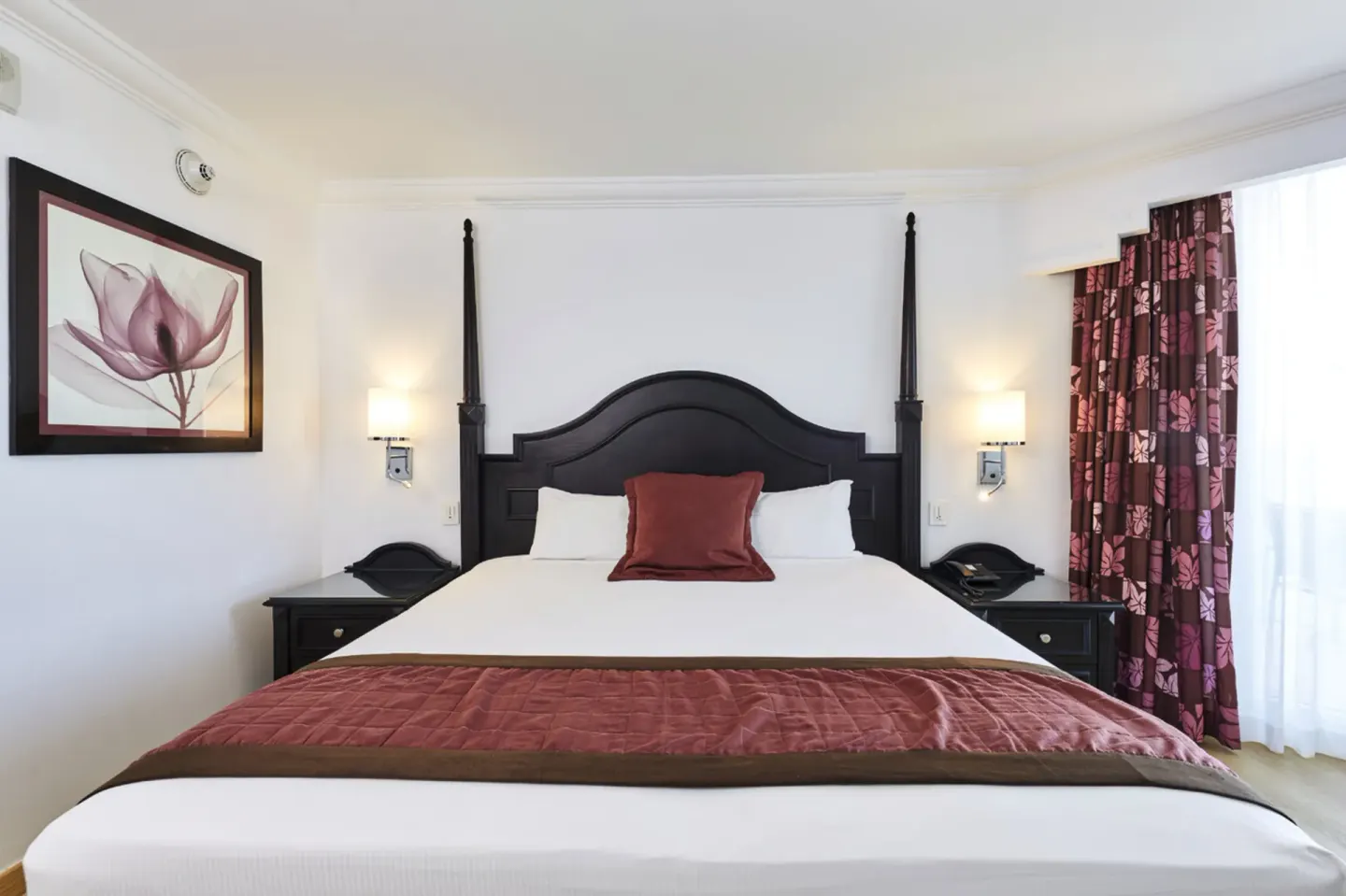 Junior Suite Ocean View bed with dark headboard at Hotel Riu Palace Paradise Island.