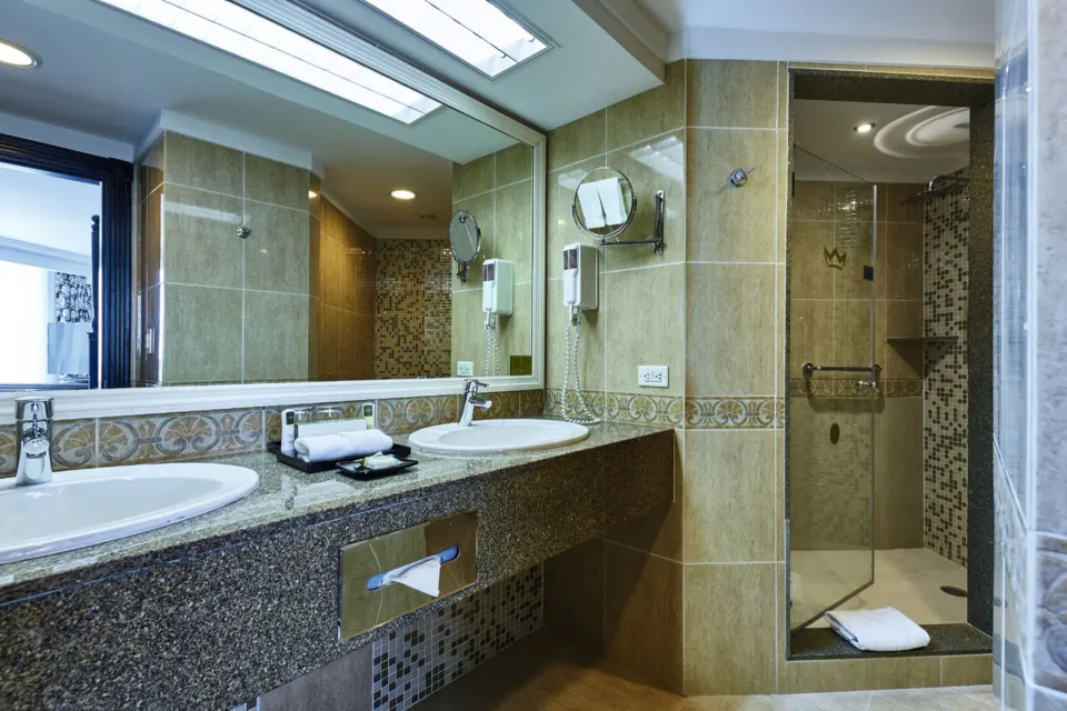 Standard Suite bathroom vanity and glass shower at Hotel Riu Palace Paradise Island.