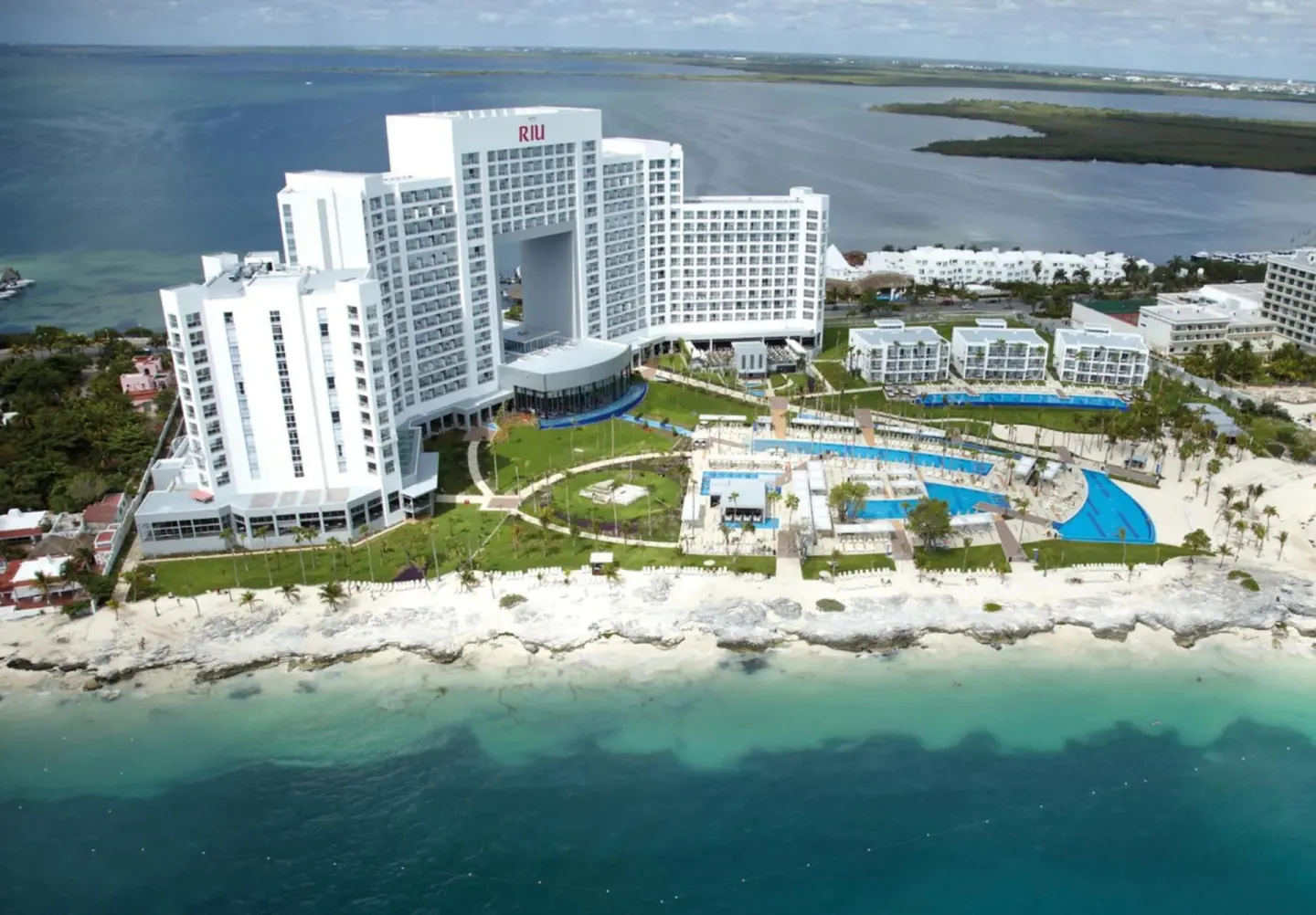 Aerial view of the beachfront resort and pools at Hotel Riu Palace Peninsula.