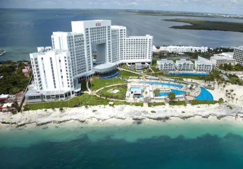 Aerial view of the beachfront resort and pools at Hotel Riu Palace Peninsula.