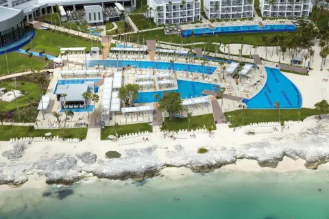 Aerial view of pools, gardens, and beachfront at Hotel Riu Palace Peninsula.