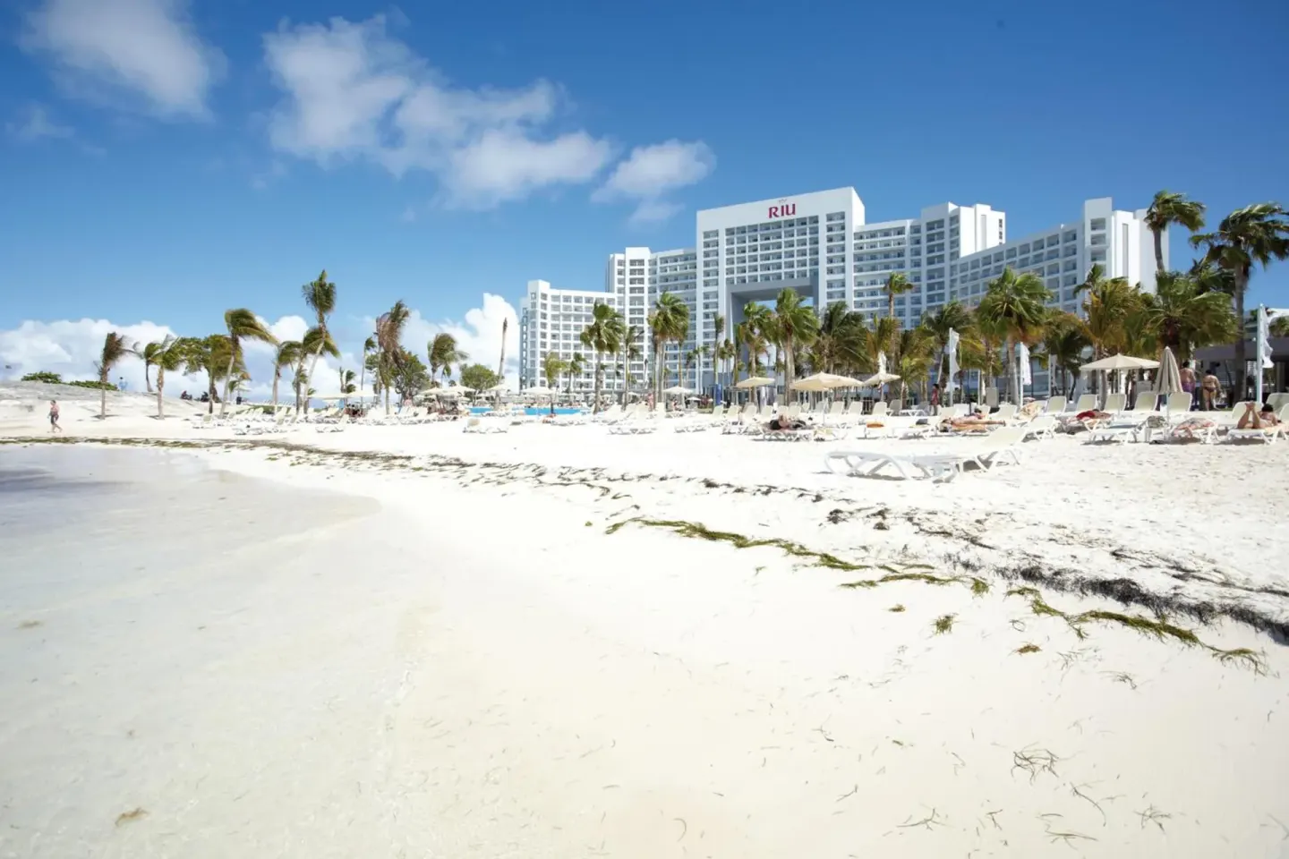 Beachfront tower and white sand at Hotel Riu Palace Peninsula.