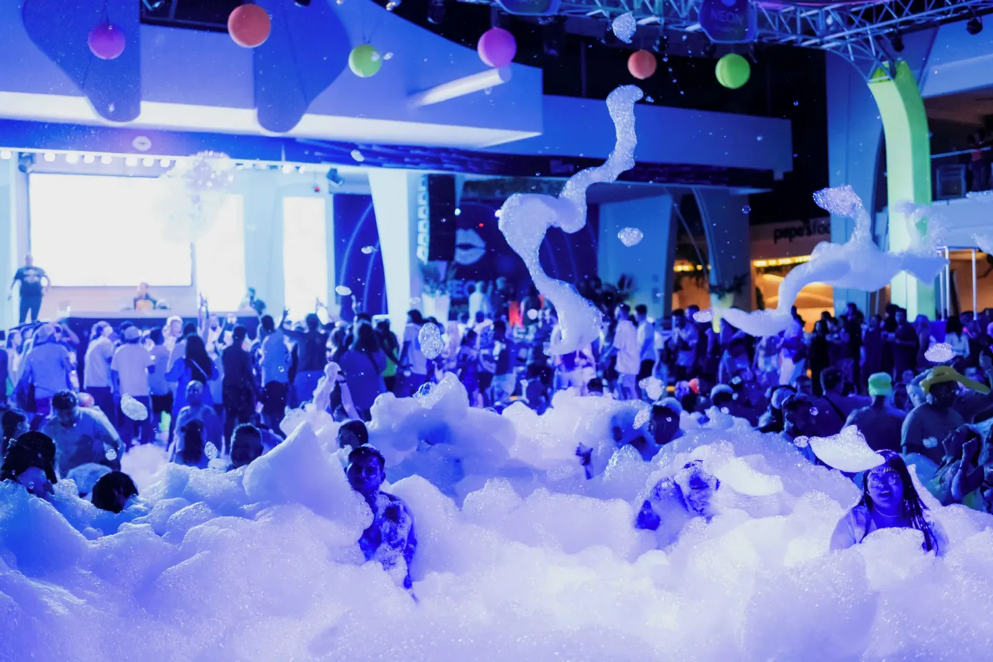 Guests stand in thick foam during a party at Hotel Riu Palace Peninsula.