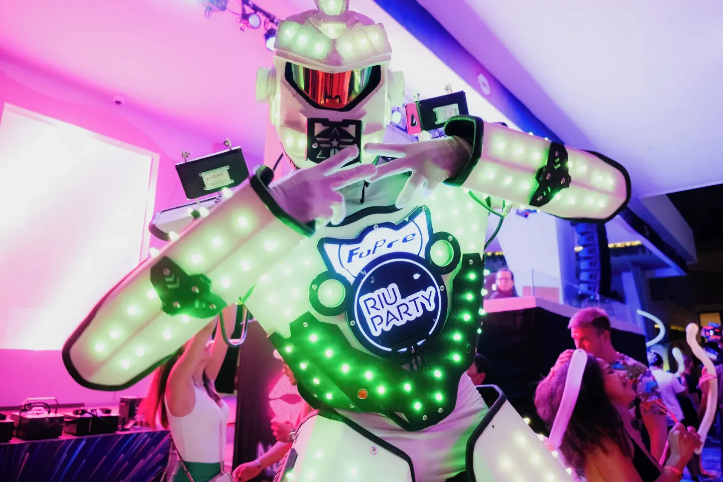 A glowing robot performer entertains dancers at Hotel Riu Palace Peninsula.