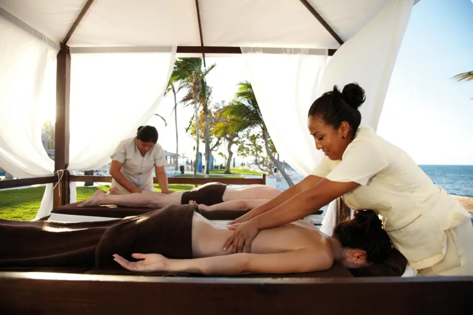 Outdoor massage cabanas with therapists and ocean views at Hotel Riu Palace Peninsula.