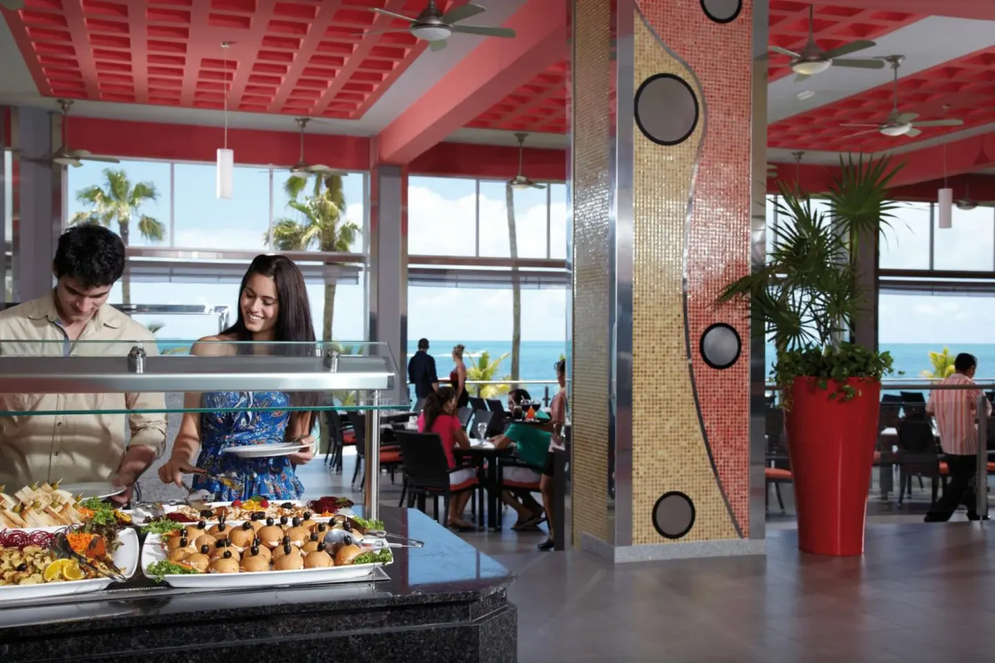 Buffet dining room with ocean view and appetizer display at Hotel Riu Palace Peninsula.