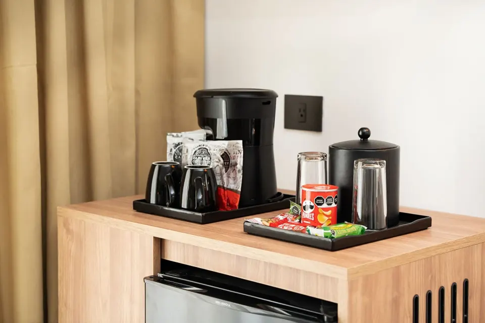 In-room coffee station and mini fridge in an Elite Club Suite Ocean View at Hotel Riu Palace Peninsula.