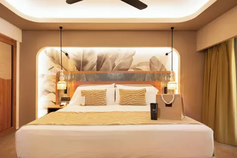 Front view of the king bed in an Elite Club Suite Ocean View at Hotel Riu Palace Peninsula.