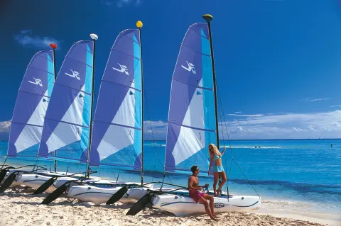 Catamarans lined on the beach at Hotel Riu Palace Punta Cana.