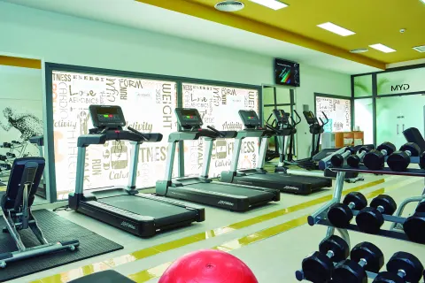 Fitness center with treadmills, ellipticals, and dumbbells at Hotel Riu Palace Punta Cana.