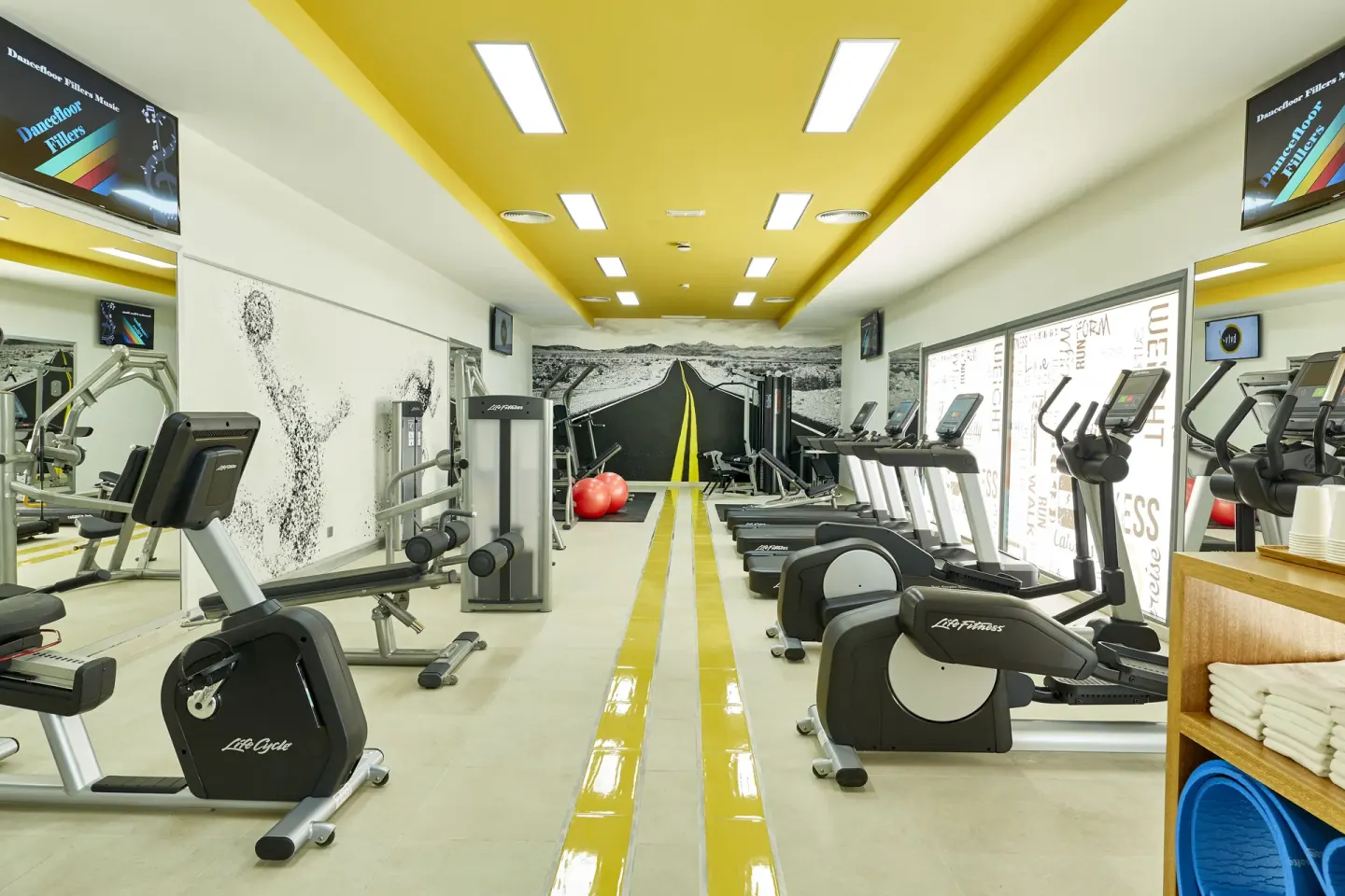 Fitness center with cardio machines and weights at Hotel Riu Palace Punta Cana.