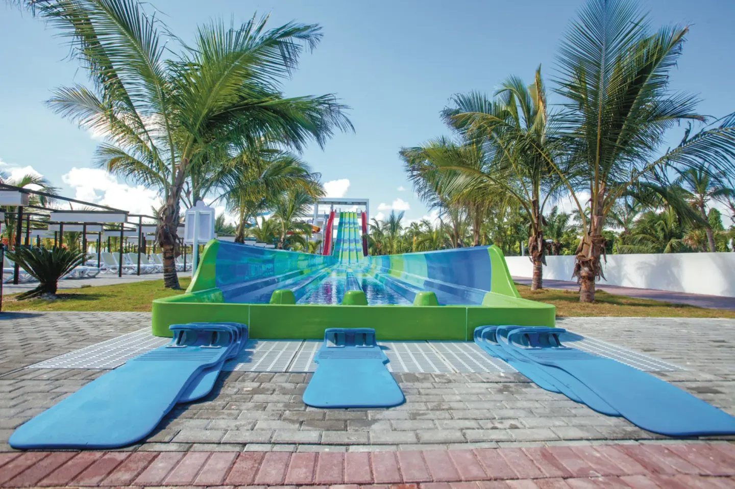 Multi-lane water slide with blue mats at Hotel Riu Palace Punta Cana.