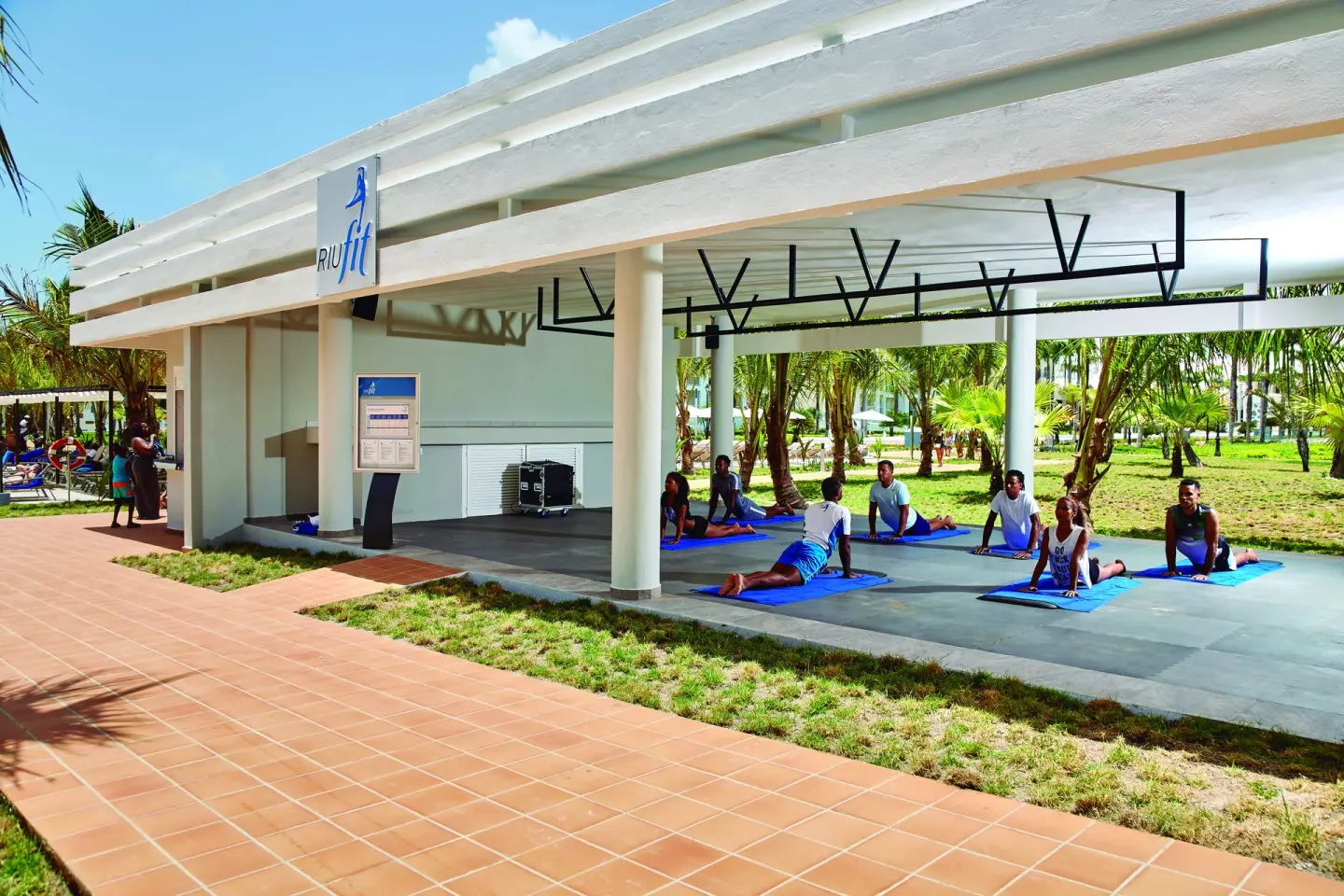 Outdoor group exercise class on mats at Hotel Riu Palace Punta Cana.