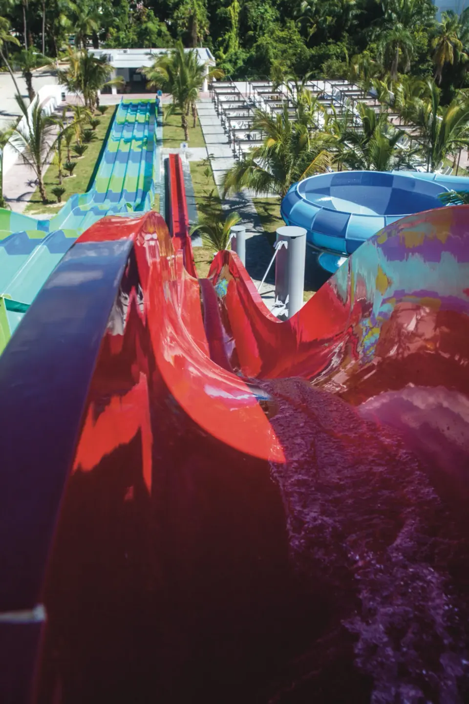 Top-down view along a red water slide at Hotel Riu Palace Punta Cana.