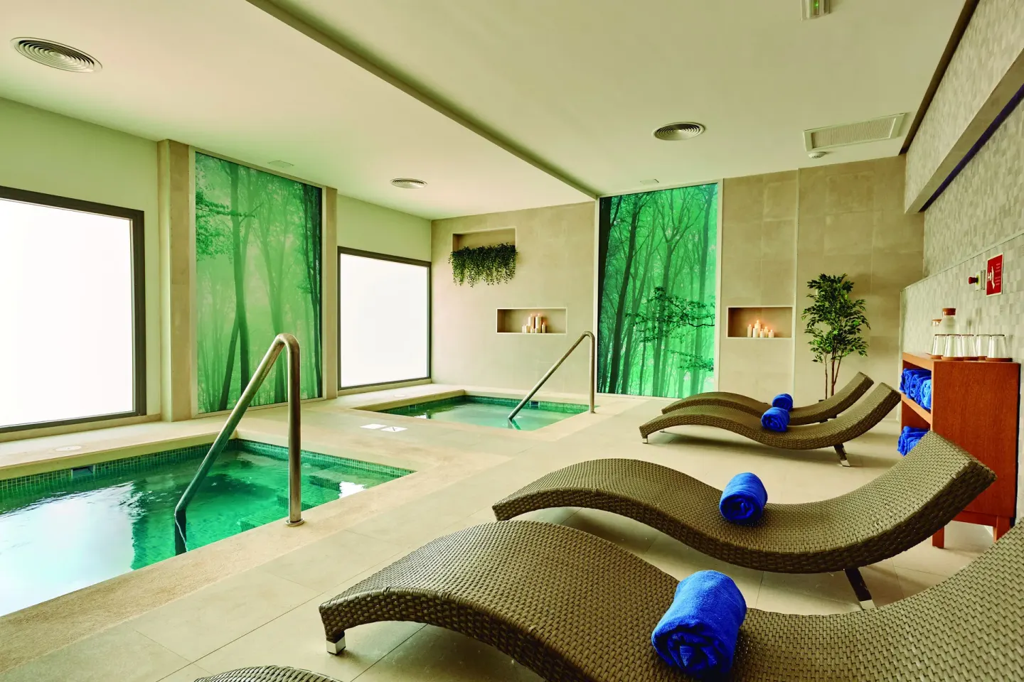 Spa hydrotherapy room with pools and loungers at Hotel Riu Palace Punta Cana.