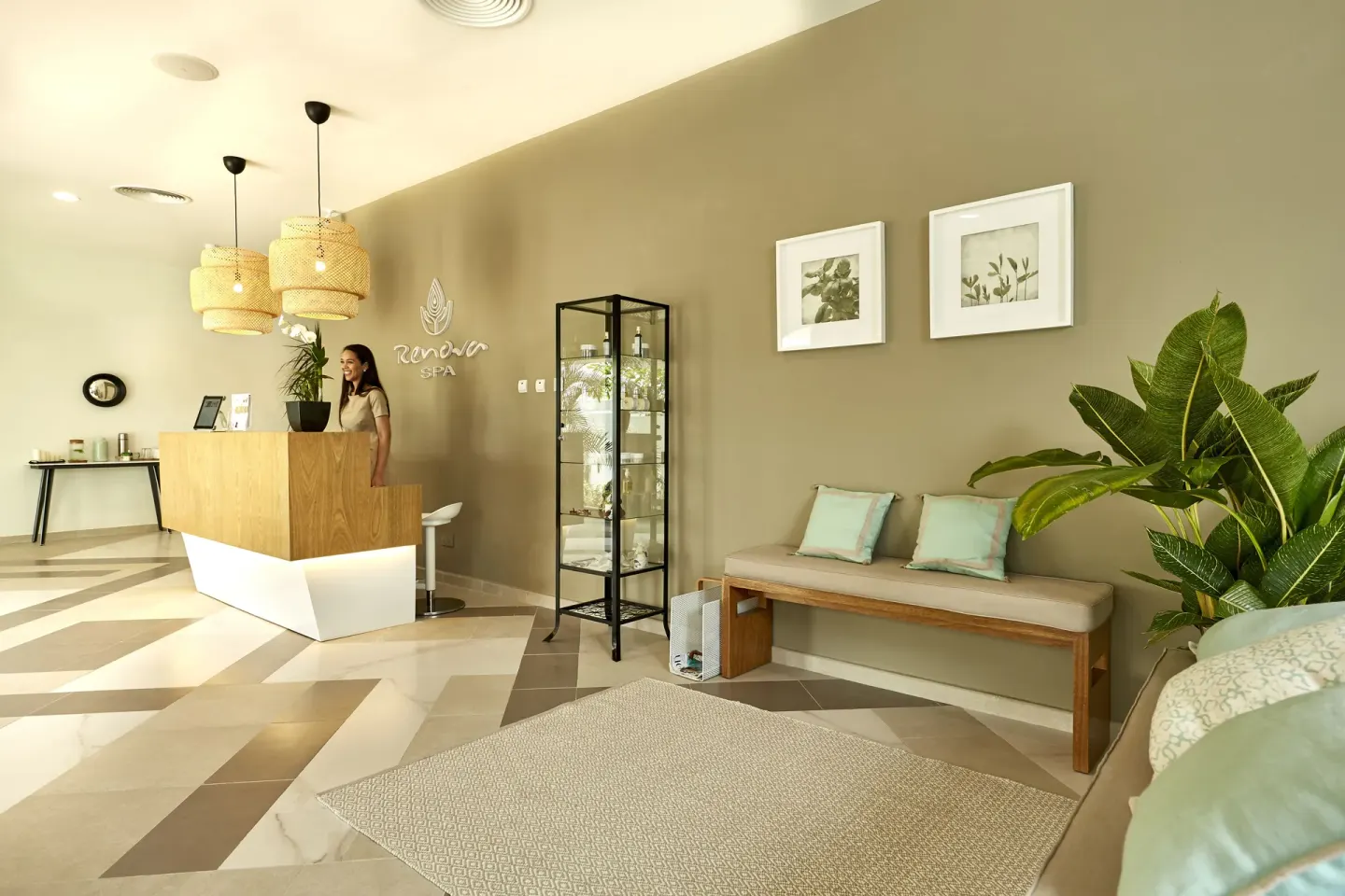 Spa reception area with seating and plants at Hotel Riu Palace Punta Cana.