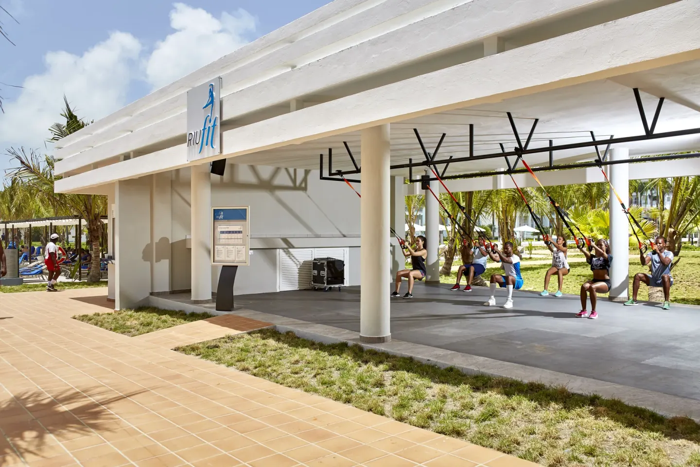 Suspension training class under a fitness pavilion at Hotel Riu Palace Punta Cana.