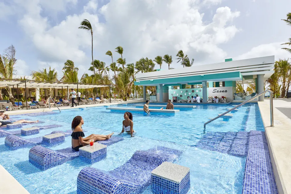 Swim-up pool bar and in-water loungers at Hotel Riu Palace Punta Cana.