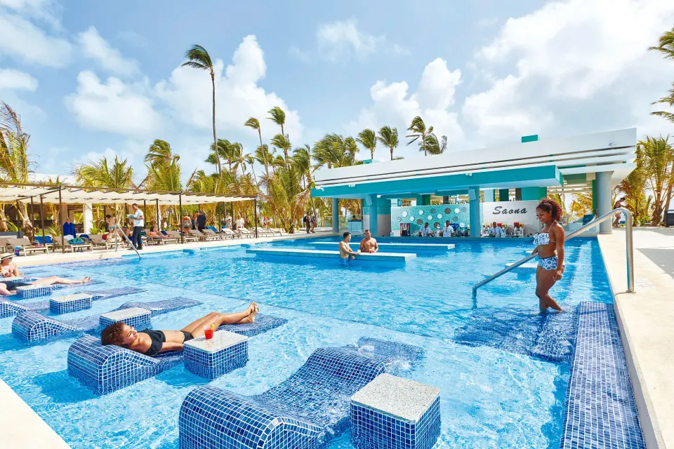 Swim-up pool area with submerged loungers at Hotel Riu Palace Punta Cana.