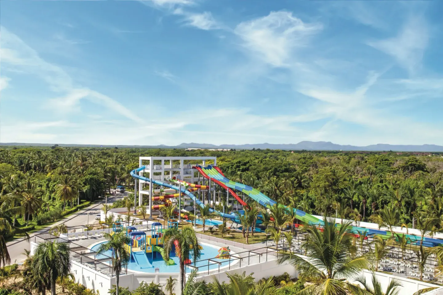 Aerial view of the water park slides and palm trees at Hotel Riu Palace Punta Cana.