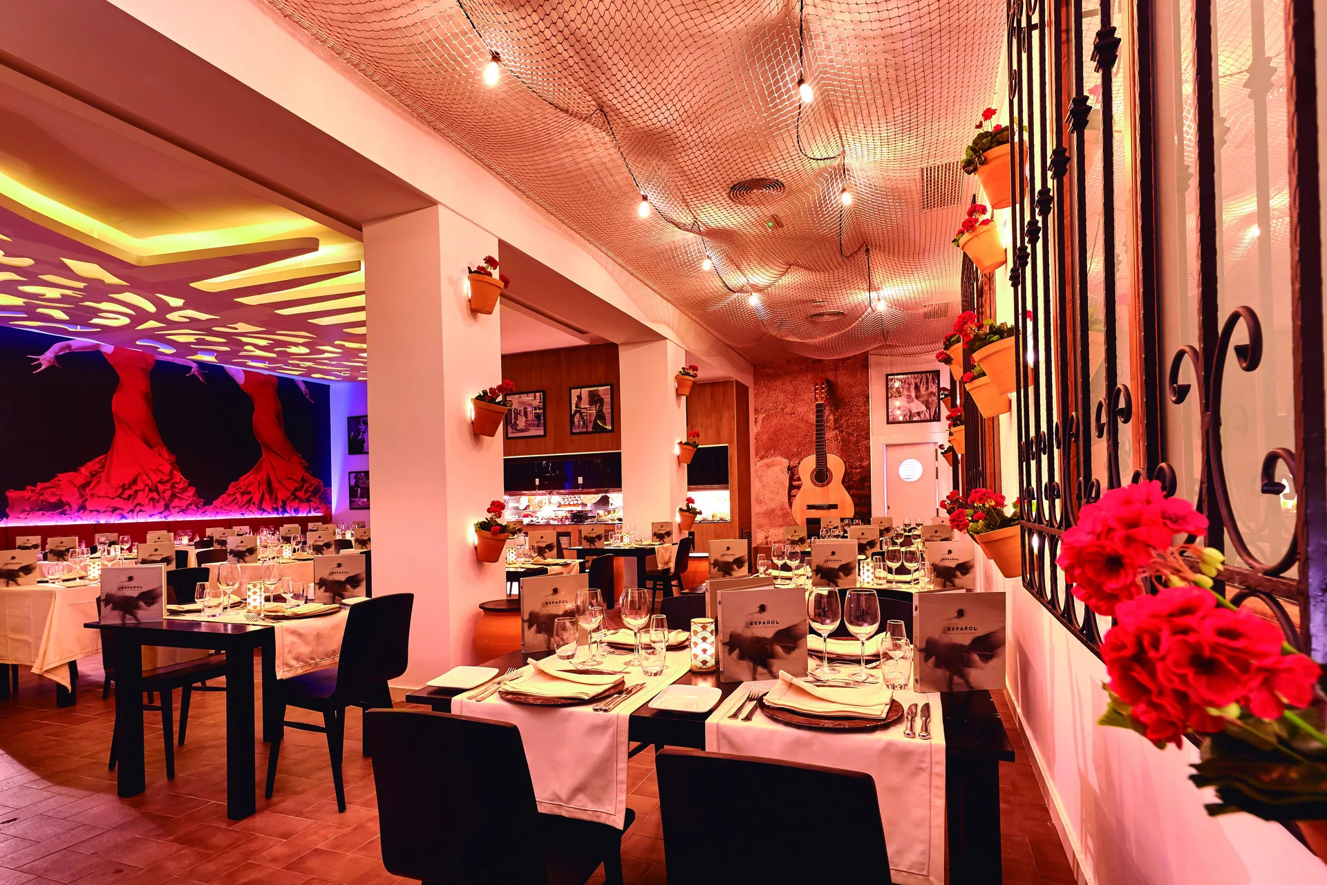 Spanish-themed restaurant dining room with red flowers at Hotel Riu Palace Punta Cana.