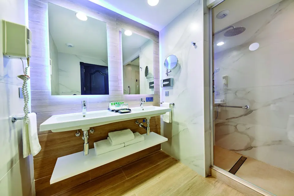 Junior Suite bathroom vanity and shower at Hotel Riu Palace Punta Cana.