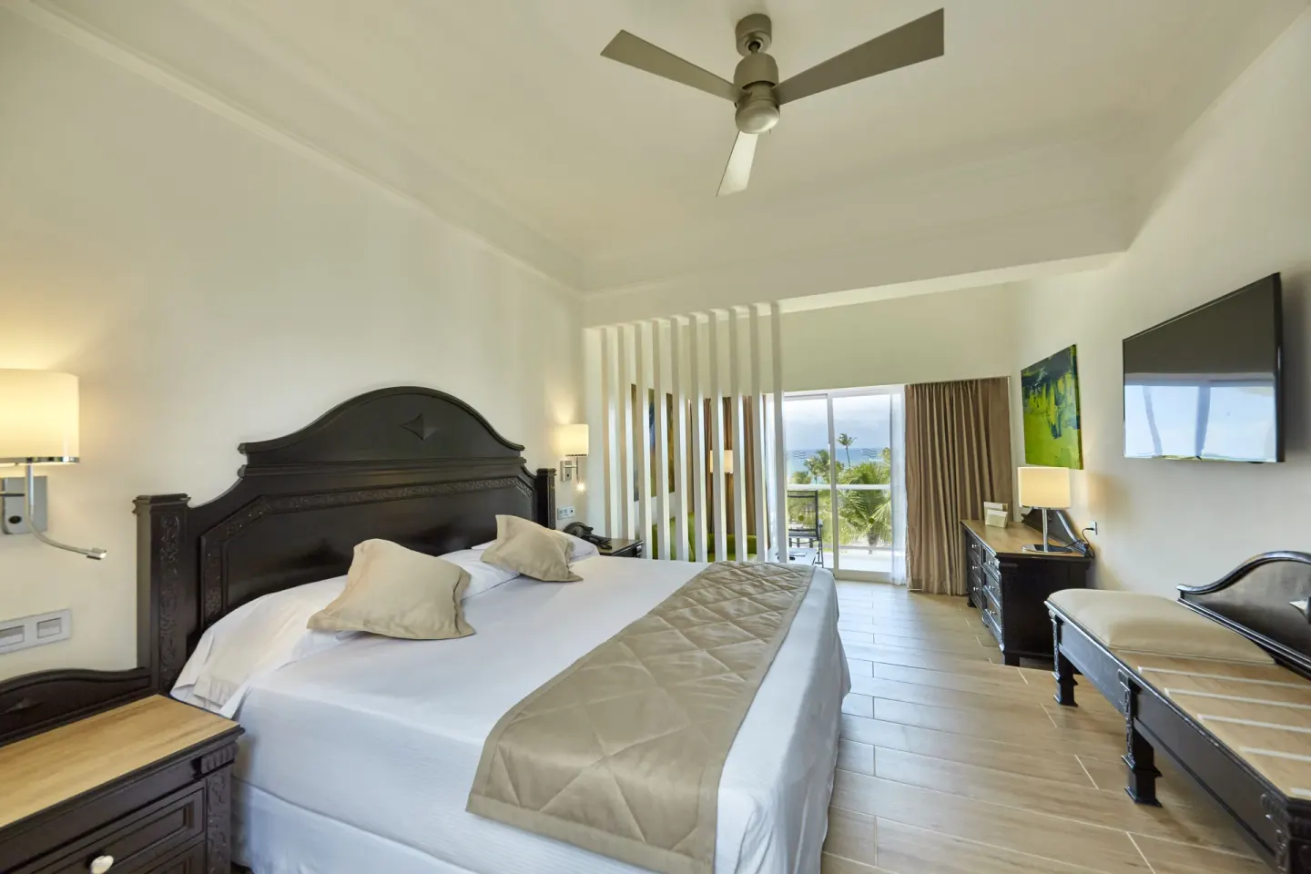 Junior Suite king bed and balcony at Hotel Riu Palace Punta Cana.