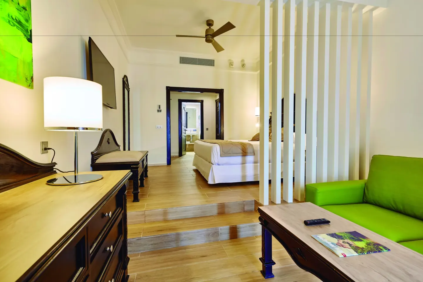 Junior Suite sitting area and bed at Hotel Riu Palace Punta Cana.
