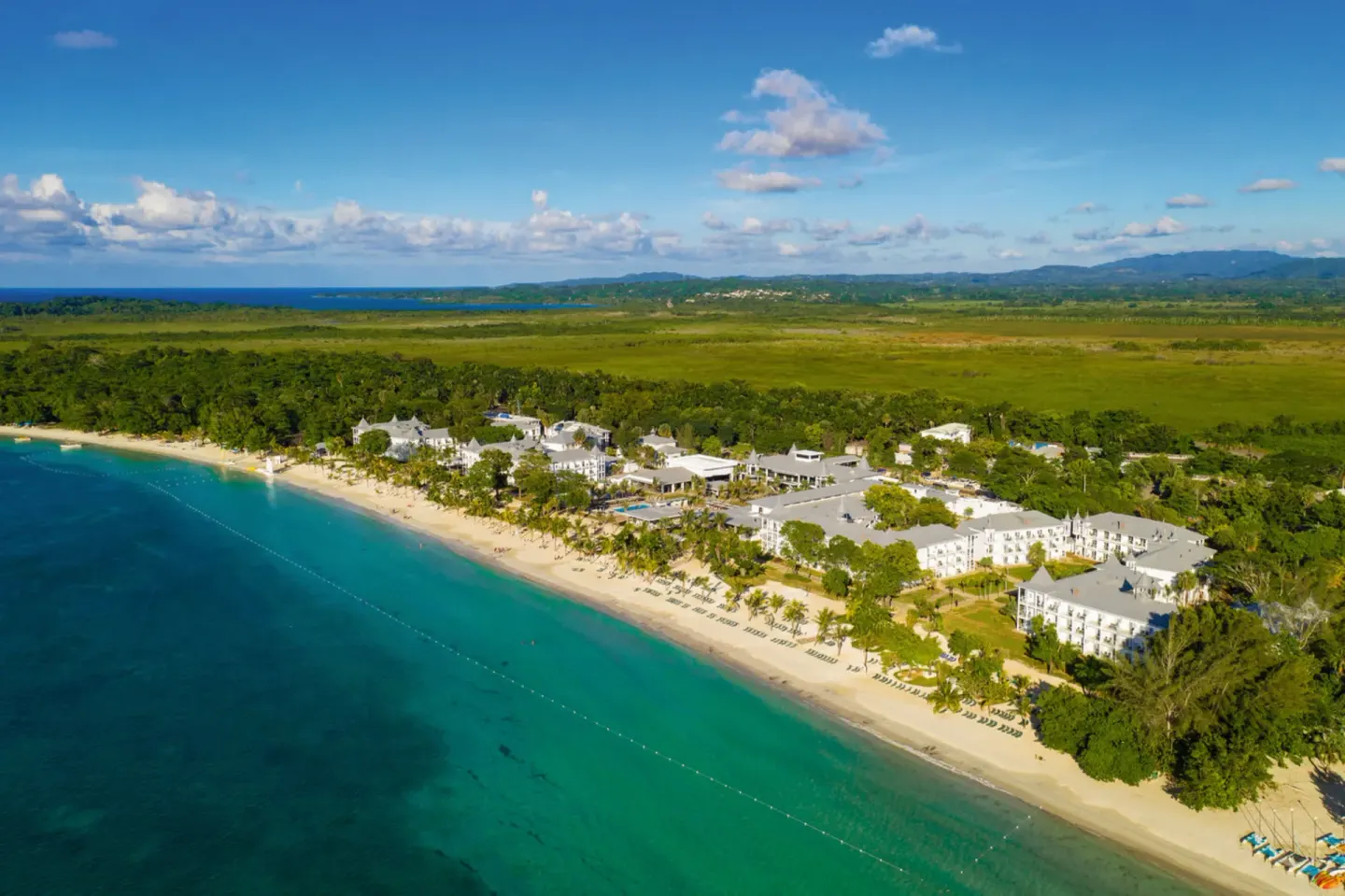 Aerial view of Hotel Riu Palace Tropical Bay along a turquoise beachfront.