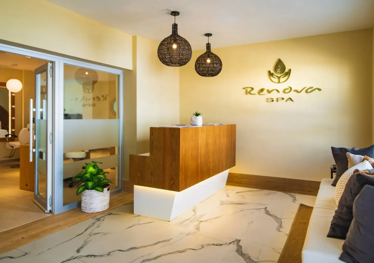 Spa reception with wood desk and wall logo at Hotel Riu Palace Tropical Bay.