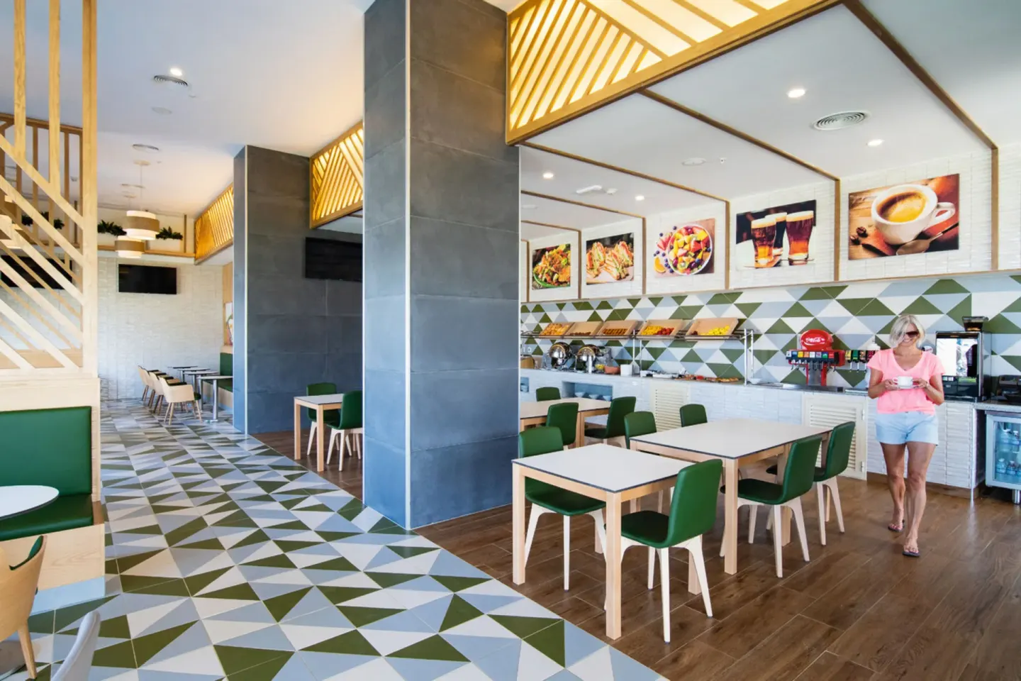 Casual buffet dining room with green chairs at Hotel Riu Palace Tropical Bay.