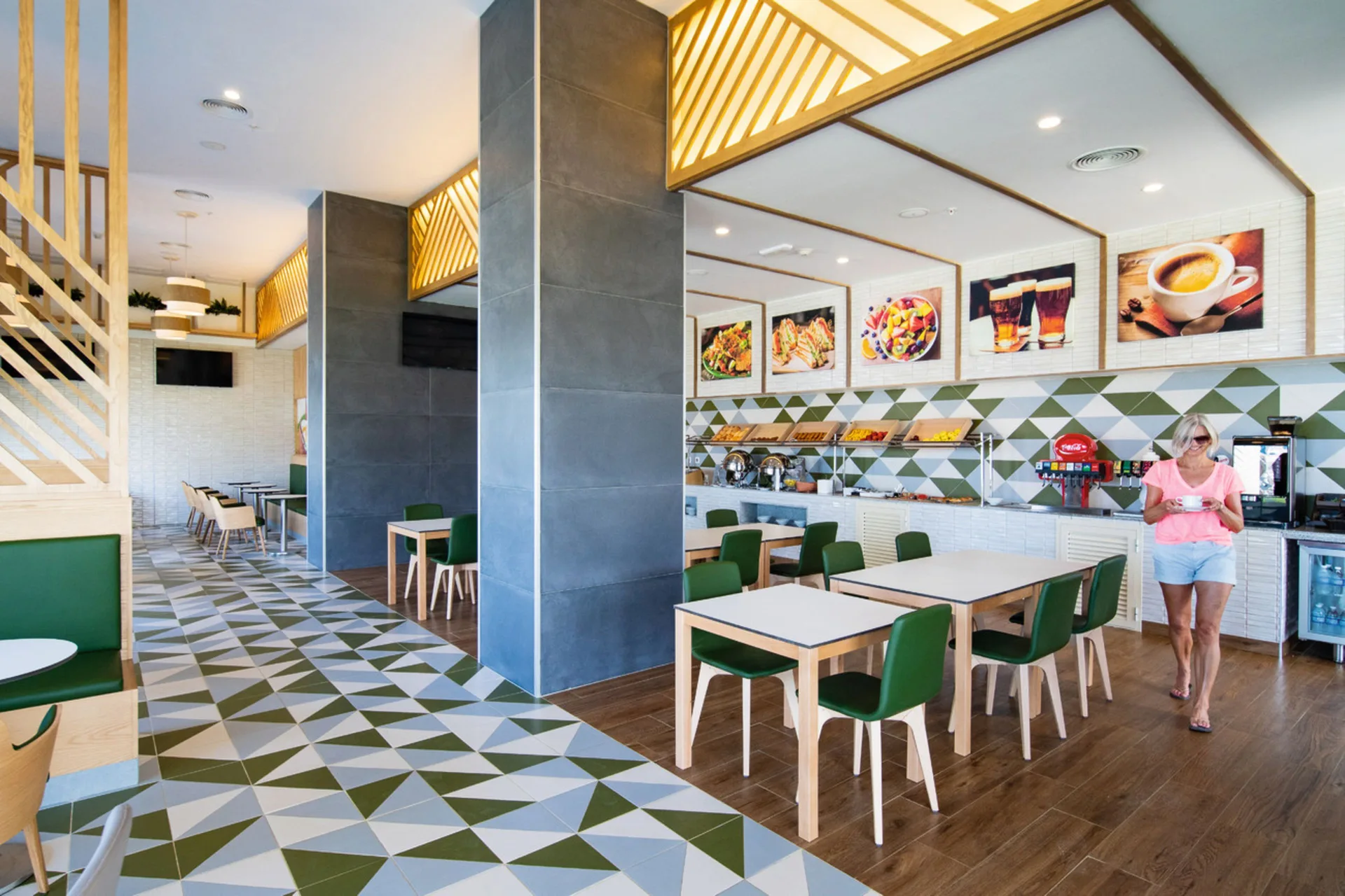 Casual buffet dining room with green chairs at Hotel Riu Palace Tropical Bay.