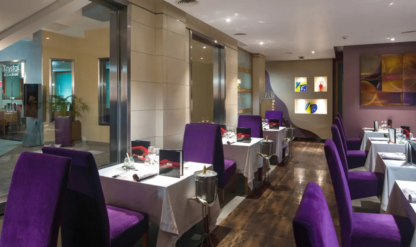 Krystal dining room with purple chairs at Hotel Riu Palace Tropical Bay.