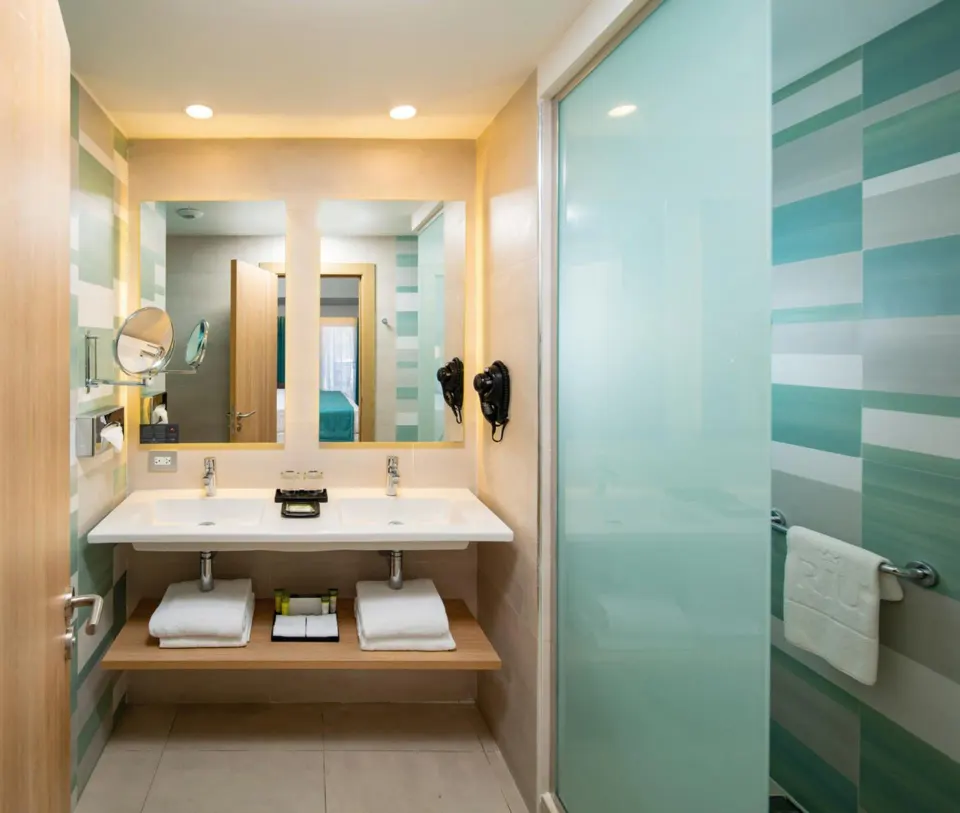 Junior Suite ocean front bathroom with double sinks at Hotel Riu Palace Tropical Bay.