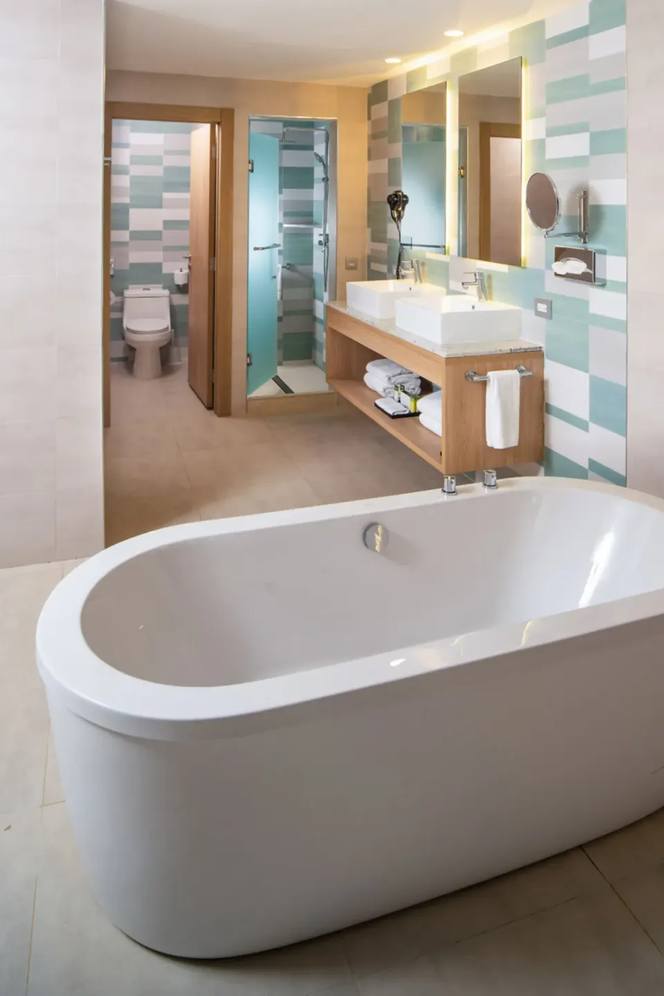 Suite bathroom tub with vanity and shower at Hotel Riu Palace Tropical Bay.