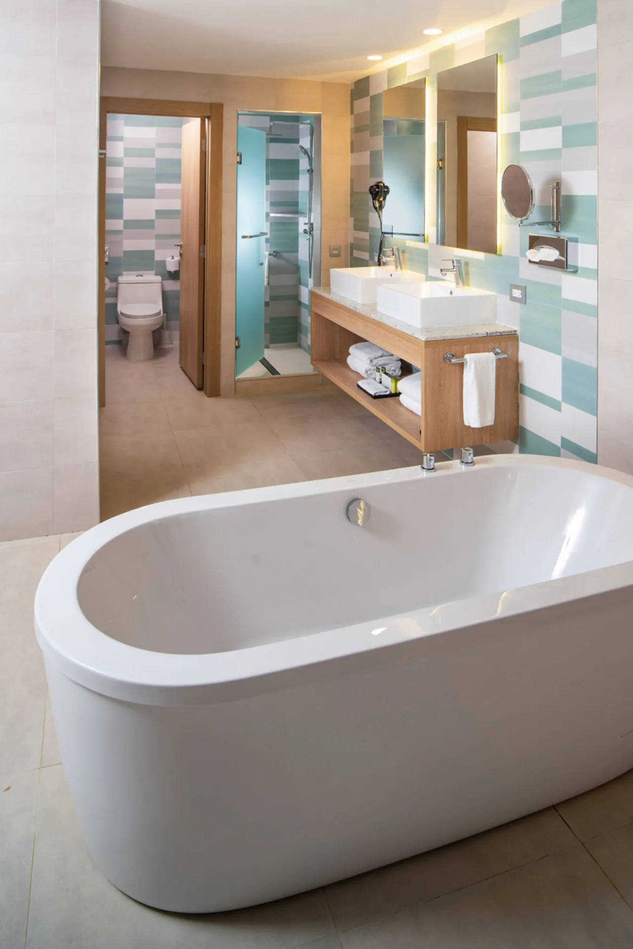 Suite bathroom tub with vanity and shower at Hotel Riu Palace Tropical Bay.