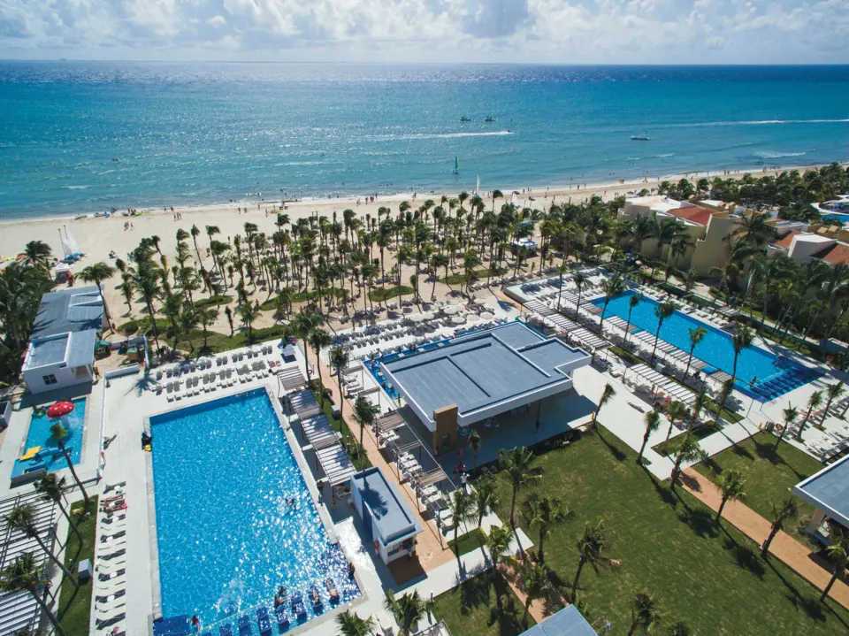 Aerial angle of the resort pools, beachfront and surrounding grounds at Hotel Riu Playacar