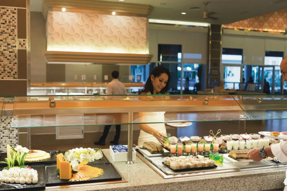 Buffet station with desserts and plated foods at Hotel Riu Playacar