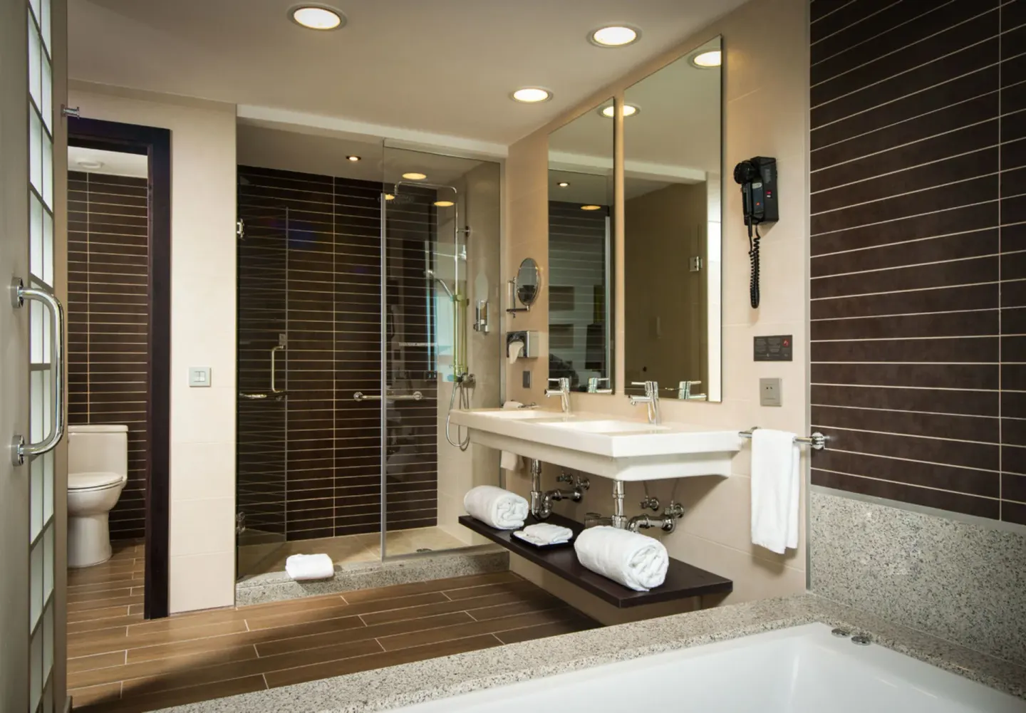 Oceanfront Junior Suite bathroom with tub, double vanity, and shower at Hotel Riu Reggae.