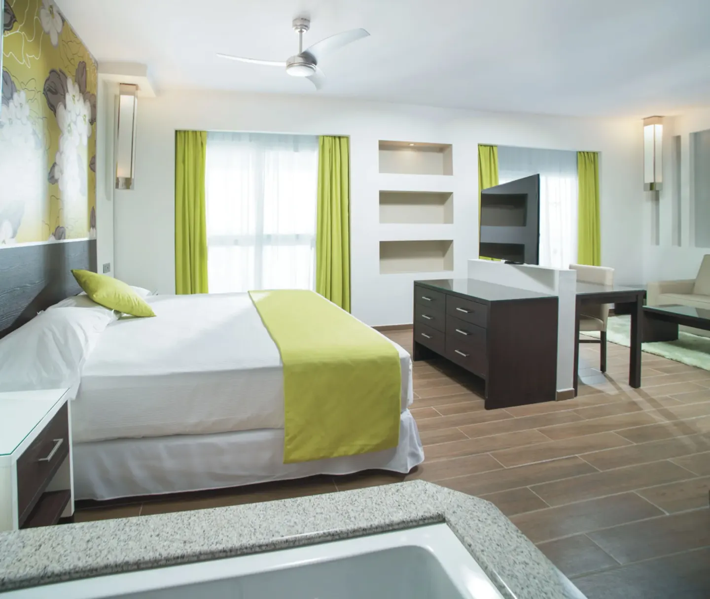 Oceanfront Junior Suite with king bed and in-room tub at Hotel Riu Reggae.