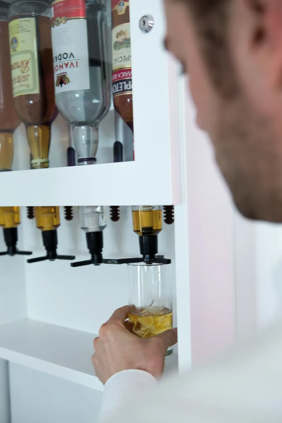 In-room liquor dispenser being used in a guest room at Hotel Riu Reggae.
